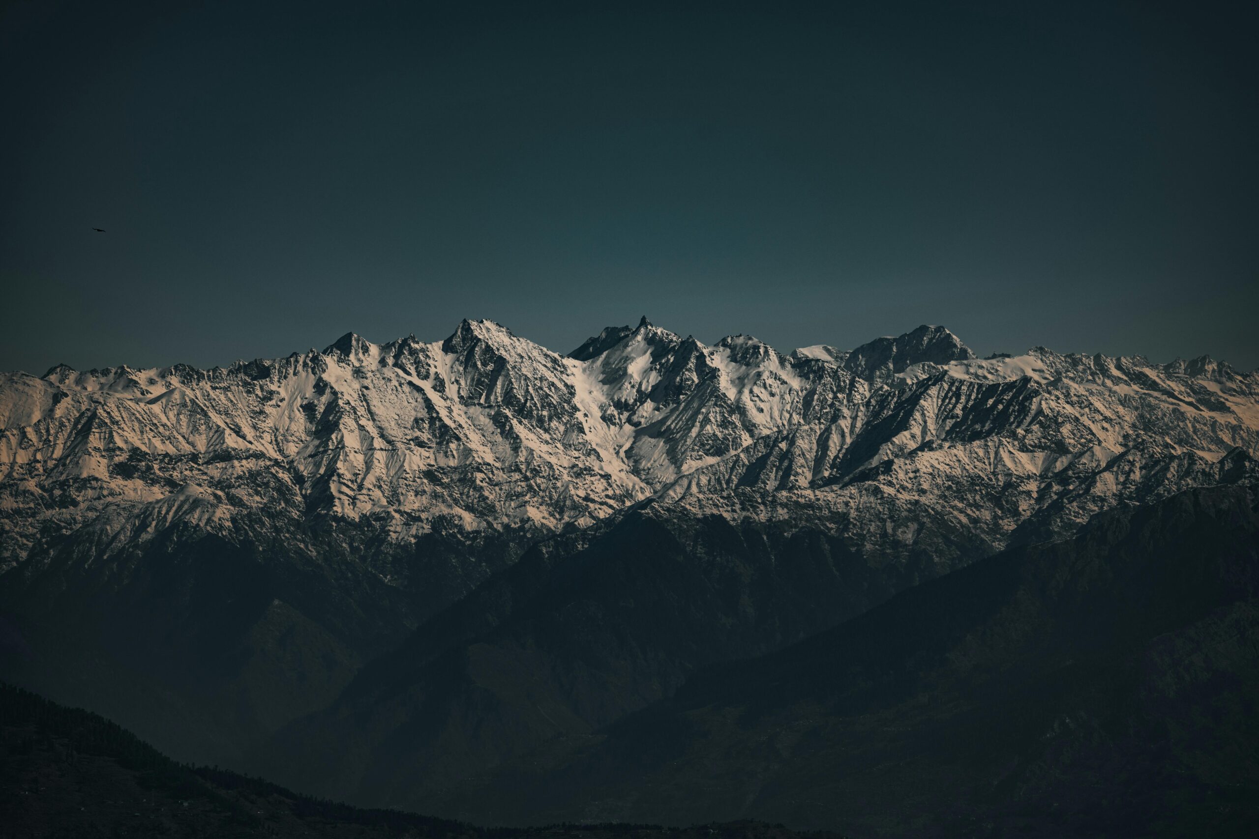 A breathtaking view of snow-covered Himalayan peaks under a clear sky.
