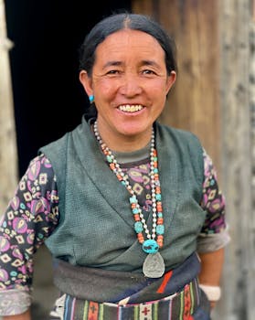 A smiling Nepali woman in traditional attire, showcasing cultural heritage in rural Nepal.